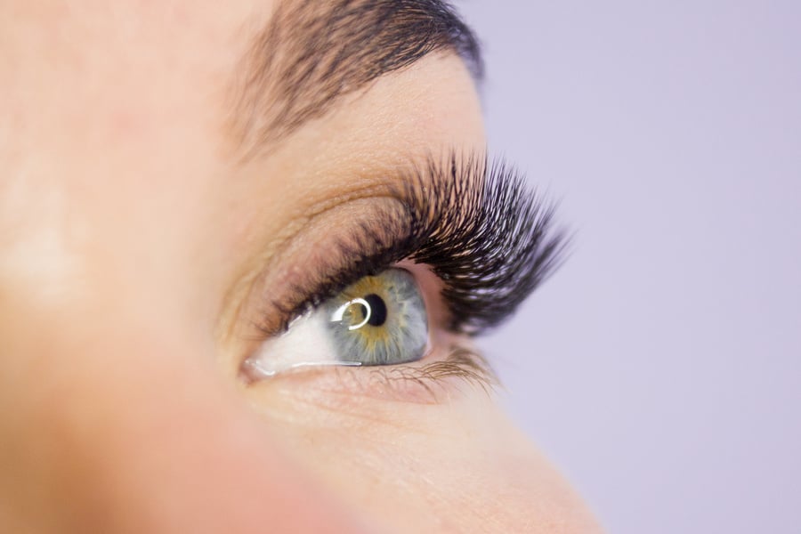 Beautiful Woman with long lashes in a beauty salon. Eyelash extension.